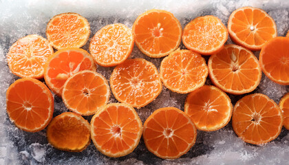 mandarine orange fruit slices on frozen surface
