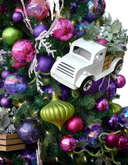 White Christmas toy truck on Christmas tree. Purple, pink and green decorations. Christmas and New...