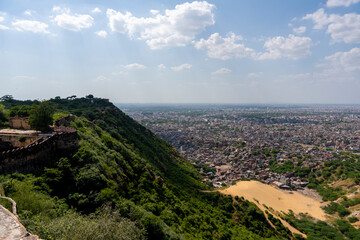 an expansive view of Jaipur, India, showcasing its densely packed urban landscape mixed with...