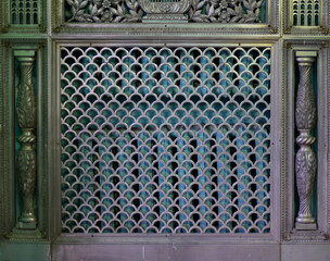 A beautiful metal (copper) grille covers two rows of heating batteries