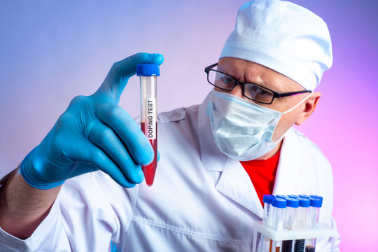 Man conducts doping test. Doctor holds test tube with blood. Doctor conducts doping test for athlete. Search for prohibited substances in blood. Anti-doping commission employee in white coat
