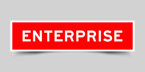 Red color square label sticker with word enterprise that inserted in gray background