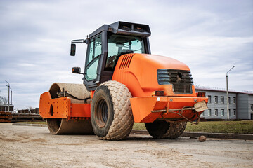 Heavy road roller working on construction site during overcast day showcasing machinery in action...