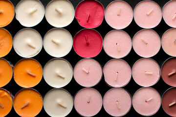 Top view of a group of colored Tea lights on black background