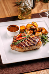 Portion of grilled beef steak served on restaurant table