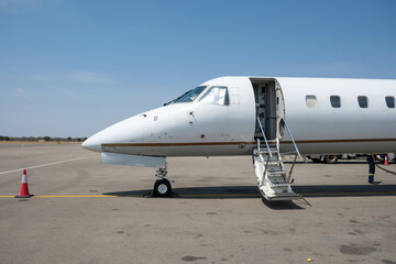 Learjet, Private Jet plane landed at Airpor runway. Blue sky background