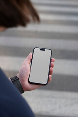 Handheld Smartphone Mockup on Urban Street Background