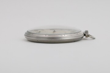 The side of a vintage pocket watch