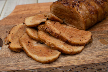 Seitan: vegan meat alternative made of washed flour gluten spices. Roasted and served on wooden board