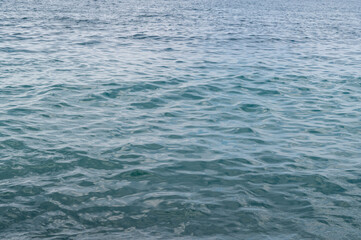 Sea surface with waves. Abstract background of water flow in ocean, sea, river, lake. Seascape wallpaper.