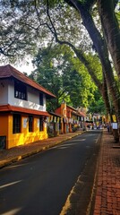 Fototapeta premium A vibrant street scene with colorful buildings and lush greenery.