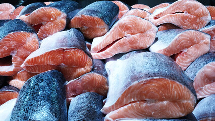 Fresh red fish salmon on supermarket. Close Up of fresh fillets salmon in display case. Uncooked fresh seafood. Sea food concept