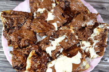 Assorted desserts of Crispy filo Phyllo pastry pie filled with Knafeh konafa topped with white and brown chocolate, and flaky Egyptian layered pastry, stuffed with chocolate baked dessert and cookies