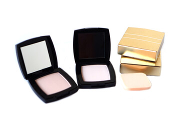 Black plastic powder cases. Cosmetic face powder or makeup puff on white background. Concept, beauty cosmetic. Facial skin care, apply on face for covering freckle spots, wrinkles.   