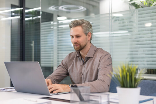Handsome successful businessman working in office