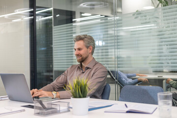 Handsome successful businessman working in office