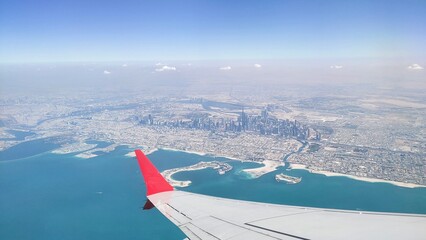 Beautiful futuristic dubai or emirate city architecture aerial birds eye morning view from plane window. Arab skyscraper and tower building constructions sky view. UAE travel and tourism concept.