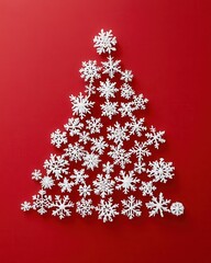 White snowflakes arranged in the shape of a Christmas tree on a red background, creating a minimalist festive look