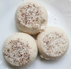 Steamed rice cake, puttu, pittu or putt popular traditional native vegetarian dish for breakfast and dinner in south Indian states Karnataka, Tamil Nadu and Kerala. Closeup macro side view.