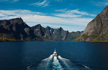 Experience the Majestic View of a Stunning Fjord with a Boat Gliding in Tranquil Waters