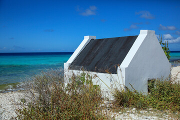 Slave huts at beach against blue sky in Bonaire, ABC Islands, Caribbean Netherlands