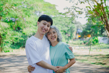 An Asian mother and daughter share a heartfelt moment, expressing their love through a warm hug. Their bond is filled with affection, care, and mutual respect, showcasing deep familial connection 