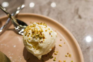 close up of vanilla ice cream with pistachio nuts toppings 
