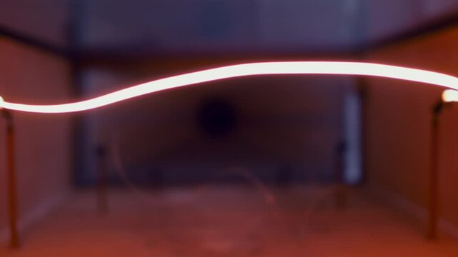 Beautiful Abstract Red Light Strings. Interior Annealing Process in Precious Metal Factory Production. Conveyor line at Non-ferrous Metal Processing Plant. Selective focus. Close Up