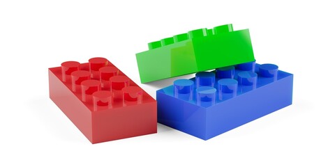 Heap of three red, green and blue colored plastic toy bricks or blocks, childhood or game background