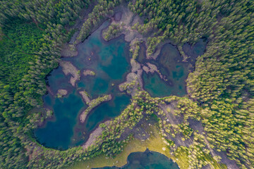Lakes with rocky shores in the middle of a forest is a typical glacial landscape of the Republic of Karelia, northwest Russia. Uksinsky esker ridge. Aerial view