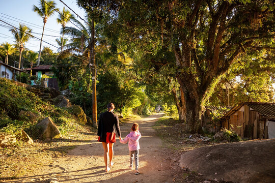 Family trail, mother and daughter on a path through the forest on an island, with travelers exploring and enjoying nature, Ilha Grande, Angra dos Reis