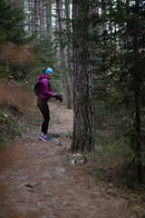 Trail runner hiking woman putting glows on trail run and hike