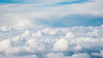A breathtaking aerial view of fluffy white clouds covering the sky, creating a mesmerizing and tranquil scene, picturesque, background, weather