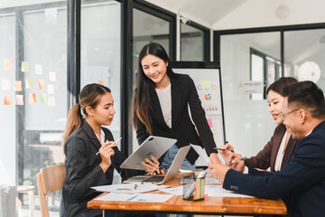 Collaborative business meeting with professionals discussing ideas and strategies. team is engaged, using digital devices and notes to enhance productivity and communication