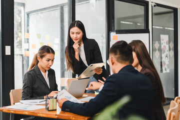 Efficient business meeting with professionals discussing strategies and analyzing data. team collaborates using laptop and tablet in modern office space