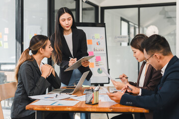 Efficient business meeting with professionals discussing strategies and analyzing data. team collaborates on charts and graphs, showcasing teamwork and productivity