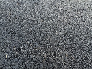 Asphalt road background. Asphalt road texture background surface. Asphalt road close-up full frame smooth black background. New asphalt road pattern background with black color top view at sunset.