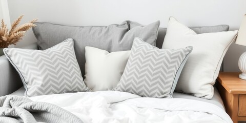 Assortment of stylish cushions in various shades of grey on a neutral background, relaxation, cushions, grey