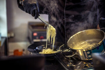 Professional chef cooks Italian Capellini.