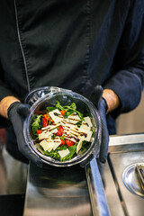 Healthy organic salad packed in a plastic container.