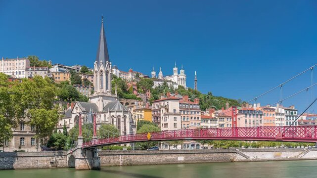 Timelapse hyperlapse of Saint George Church, Quais de Saone, and Fourviere Basilica from a footbridge in Vieux Lyon, France, showcasing historic architecture, reflections and a scenic river view