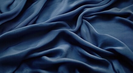Fototapeta premium Dark blue silk fabric with folds, a background for design and decoration