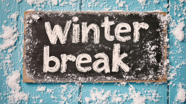 Winter break chalkboard sign on a snow-dusted blue wooden surface, evoking the cozy feeling of a school or college holiday season