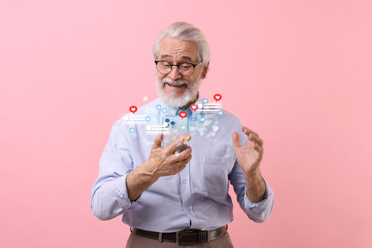 Happy man using mobile phone on pink background. Different notification signs over gadget - Powered by Adobe