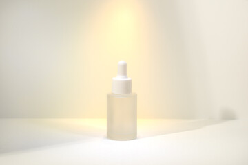 Minimalist amber glass dropper bottle for essential oils, skincare serums, or cosmetic products isolated on white background