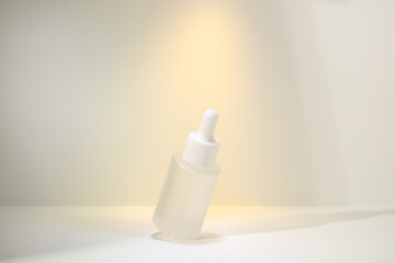 Minimalist amber glass dropper bottle for essential oils, skincare serums, or cosmetic products isolated on white background