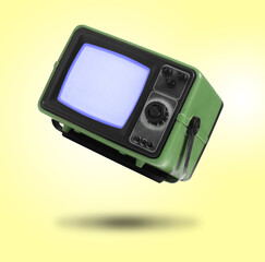 Retro TV set in air on yellow background