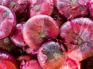 Background of red raw onion. Allium red. Close-up of onions at the market.