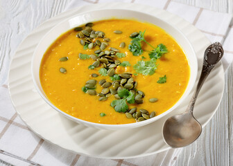 Pumpkin Red Lentil Soup in white bowl, top view