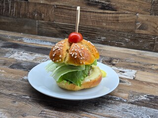 homemade hamburgers with tomato on a white plate